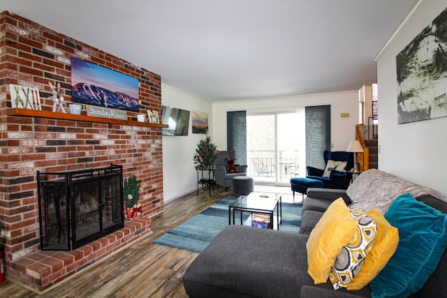 135 Vernon St Unit 4E, Bethel, ME 04217 - living area with wood finished floors, crown molding, and a fireplace