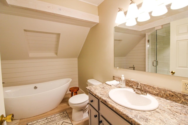 135 Vernon St Unit 4E, Bethel, ME 04217 - bathroom featuring a freestanding bath, vanity, a stall shower, vaulted ceiling, and wood finished floors