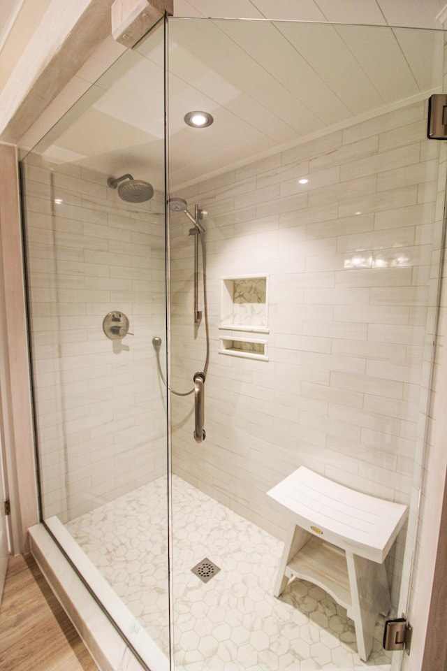 bathroom featuring hardwood / wood-style flooring and an enclosed shower