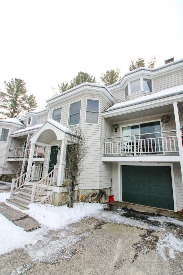 view of front facade featuring a balcony and a garage