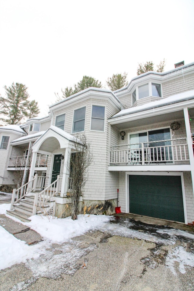 135 Vernon St Unit 4E, Bethel, ME 04217 - view of front of home featuring a garage, driveway, and a balcony