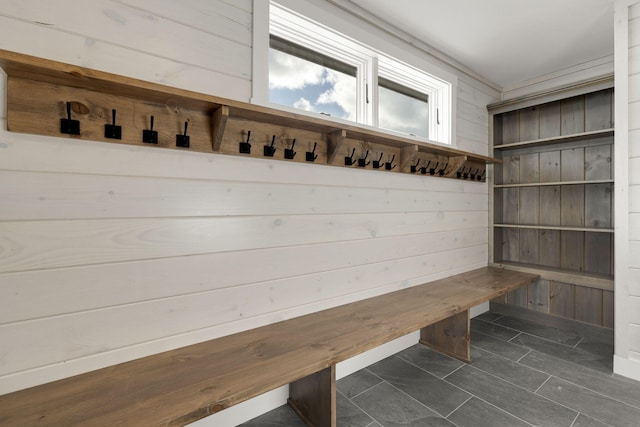 mudroom with wood walls