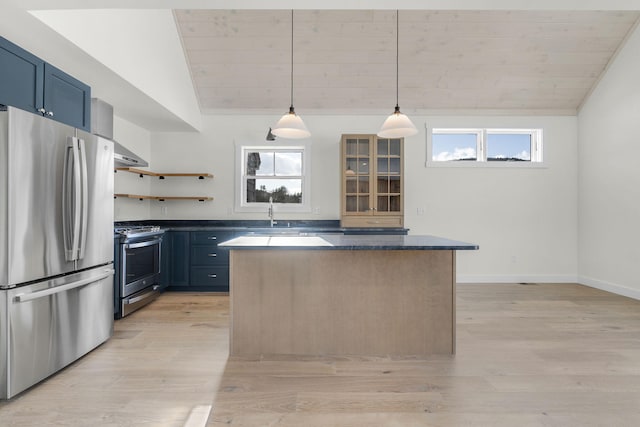 kitchen featuring blue cabinetry, appliances with stainless steel finishes, vaulted ceiling, and hanging light fixtures