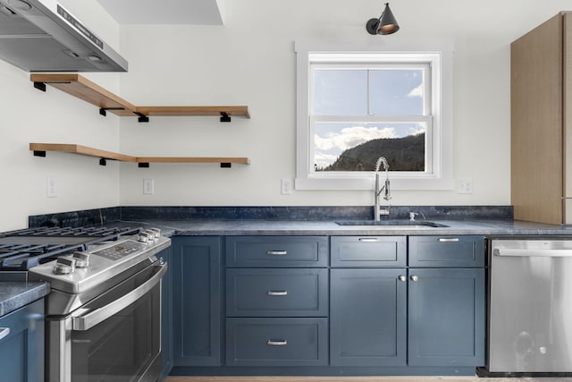 kitchen featuring sink, stainless steel appliances, exhaust hood, and blue cabinetry