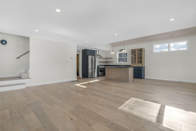 unfurnished living room featuring light hardwood / wood-style floors and sink