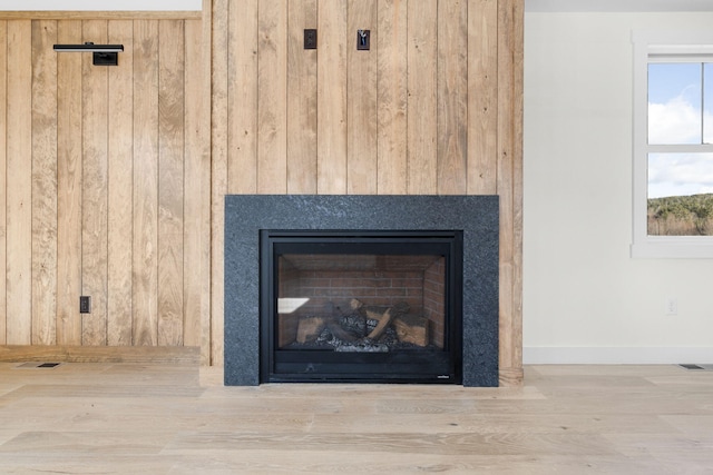 room details with wood-type flooring and wooden walls