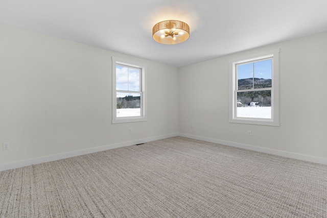 carpeted empty room with a healthy amount of sunlight