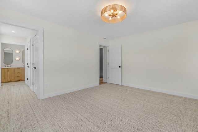 unfurnished room featuring light colored carpet