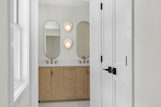 bathroom with vanity and a wealth of natural light