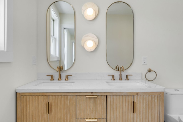 bathroom featuring vanity and toilet