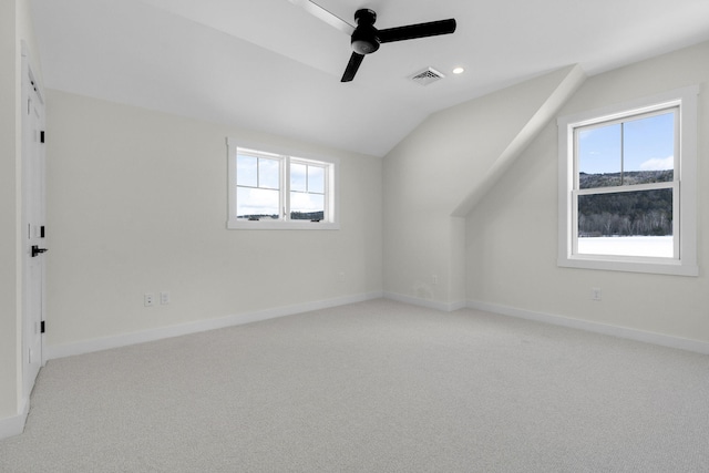 bonus room with lofted ceiling, a wealth of natural light, light colored carpet, and ceiling fan