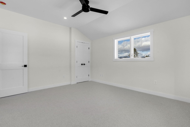 unfurnished room with vaulted ceiling, carpet floors, and ceiling fan