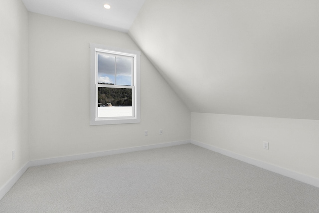 bonus room featuring vaulted ceiling and carpet