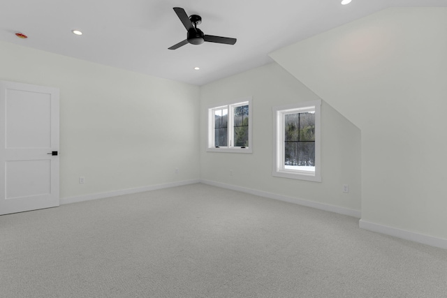 bonus room featuring light carpet, lofted ceiling, and ceiling fan