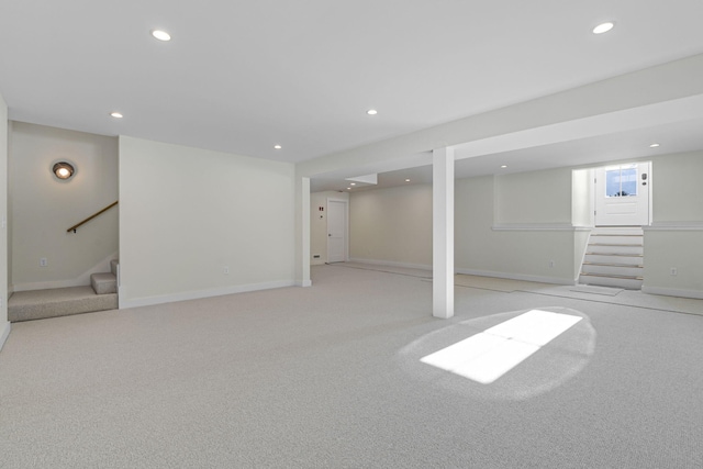 basement featuring light carpet