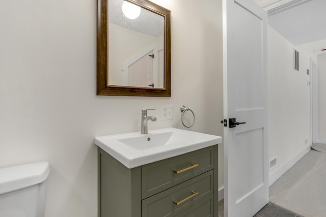 bathroom featuring vanity and toilet