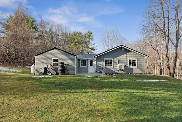 view of front of house featuring cooling unit and a front yard