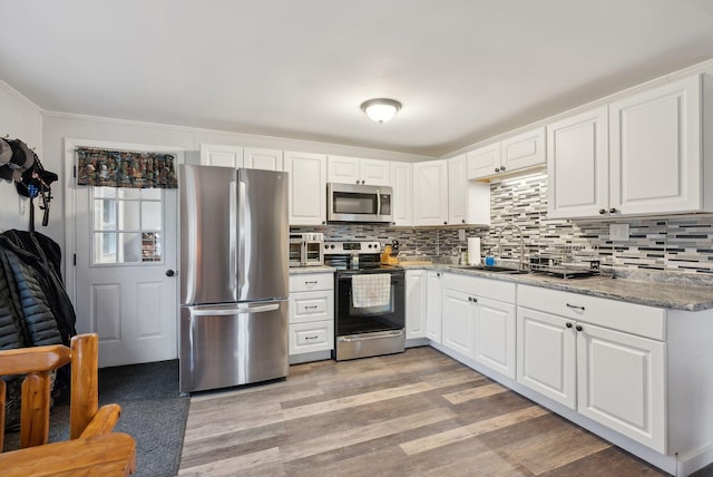 kitchen featuring sink, white cabinets, and appliances with stainless steel finishes