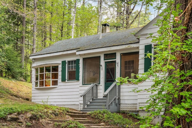 137 Birch Ln, Belgrade, ME 04917 - view of front of property with a shingled roof, entry steps, and a chimney