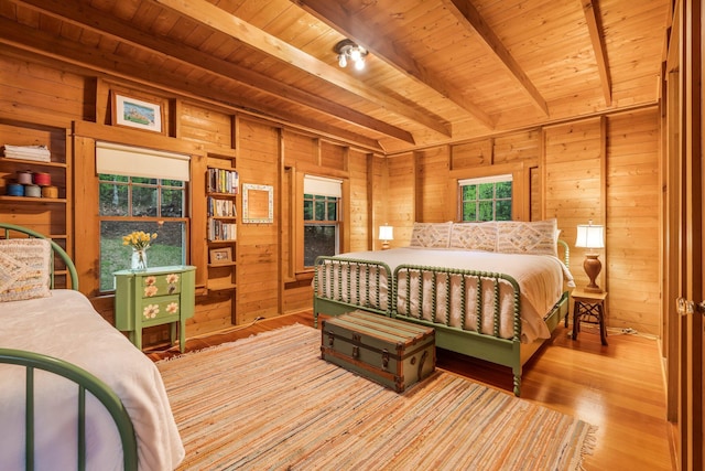 137 Birch Ln, Belgrade, ME 04917 - bedroom featuring wooden ceiling with exposed beams, wooden walls, and wood finished floors