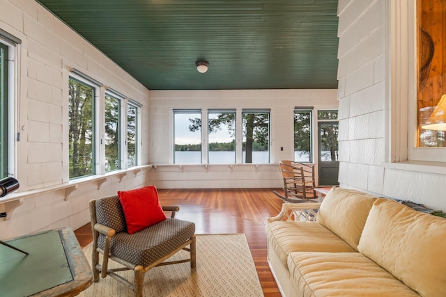 137 Birch Ln, Belgrade, ME 04917 - sunroom / solarium featuring wood finished floors and a water view