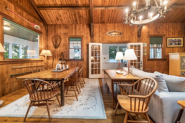 137 Birch Ln, Belgrade, ME 04917 - dining room with wooden ceiling, wood walls, a chandelier, wood finished floors, and french doors