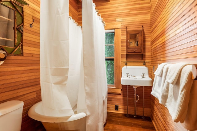 137 Birch Ln, Belgrade, ME 04917 - full bath featuring wood walls, toilet, wood finished floors, and a shower with curtain