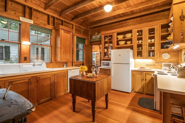 137 Birch Ln, Belgrade, ME 04917 - kitchen with white appliances, wood ceiling with exposed beams, brown cabinets, wooden walls, and light wood-type flooring