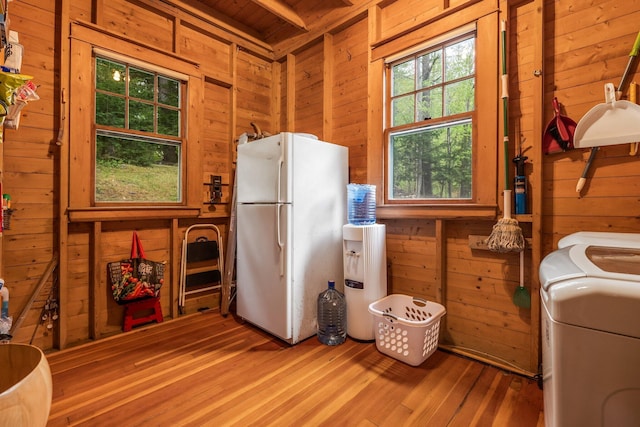 137 Birch Ln, Belgrade, ME 04917 - kitchen with freestanding refrigerator, wooden walls, wood finished floors, wood ceiling, and separate washer and dryer