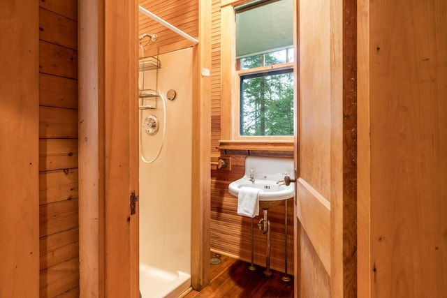 137 Birch Ln, Belgrade, ME 04917 - bathroom with a shower stall, wood finished floors, and wood walls