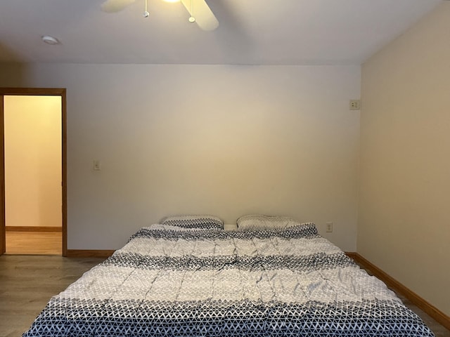 bedroom with hardwood / wood-style floors and ceiling fan