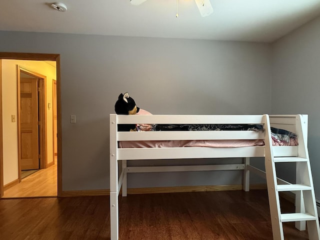 unfurnished bedroom featuring hardwood / wood-style floors and ceiling fan