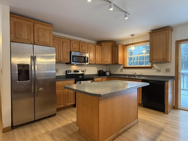 kitchen with a kitchen island, light hardwood / wood-style floors, stainless steel appliances, and track lighting