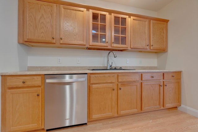 kitchen featuring light brown cabinets, light hardwood / wood-style floors, stainless steel dishwasher, and sink