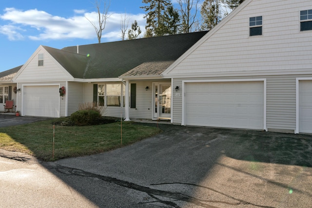 view of front of house featuring a front yard and a garage