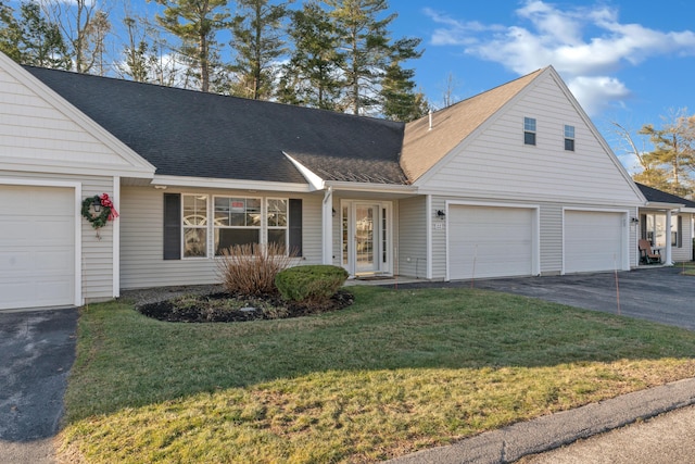 view of front of property featuring a front yard and a garage