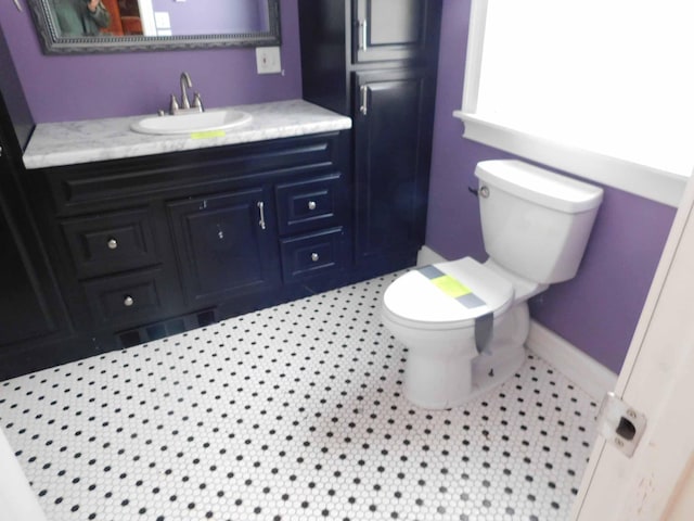 bathroom featuring tile patterned flooring, vanity, and toilet