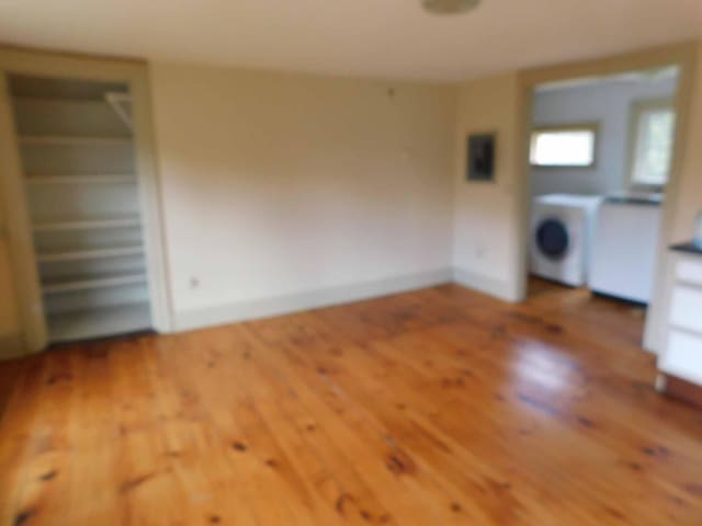 interior space with washer / dryer, radiator, and wood-type flooring