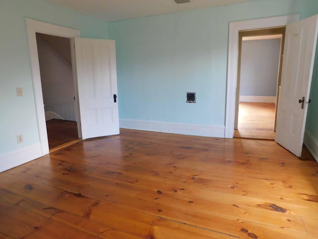 unfurnished bedroom with wood-type flooring