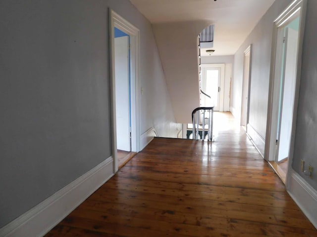 corridor with dark hardwood / wood-style floors