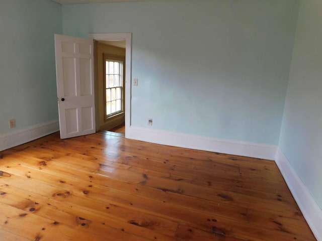 empty room with hardwood / wood-style floors