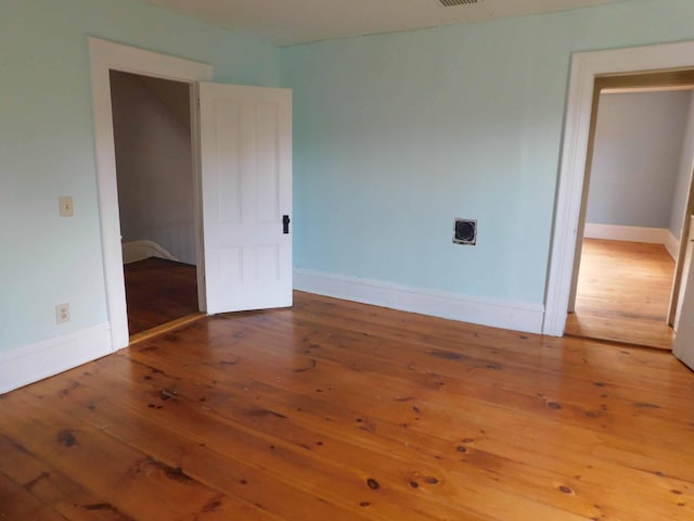 spare room featuring hardwood / wood-style floors