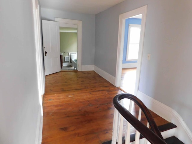 corridor featuring dark wood-type flooring