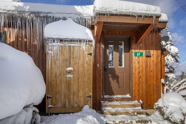 view of snow covered property entrance