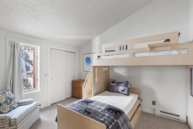 bedroom featuring light carpet, vaulted ceiling, a closet, and a baseboard heating unit