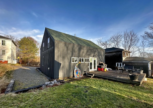 rear view of property with a lawn and a deck