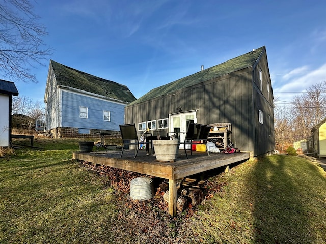 back of property with a lawn and a wooden deck