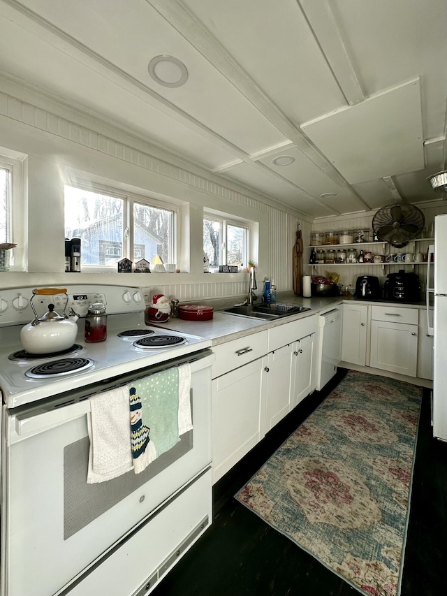 kitchen featuring white cabinetry, white appliances, and sink