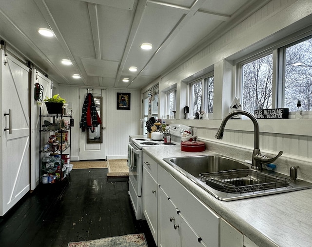 kitchen featuring white cabinets, dark hardwood / wood-style floors, white electric stove, and sink