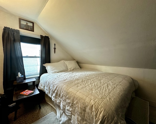 carpeted bedroom featuring vaulted ceiling